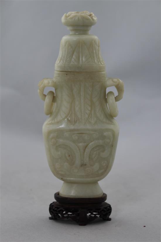 A Chinese greyish white bowenite jade archaistic vase and cover, 20th century, 17cm, wood stand